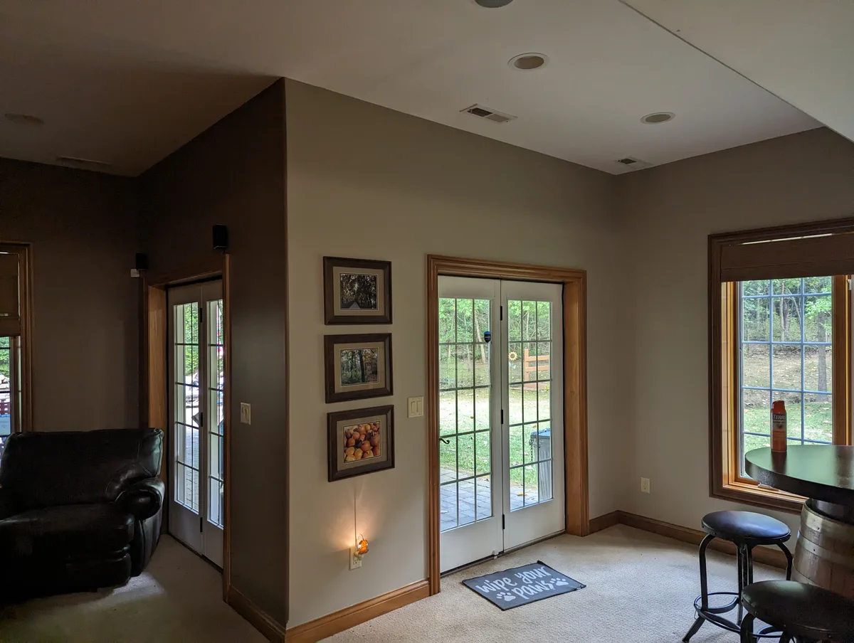 Columbus 2 Story Addition before: Interior with beige walls, light carpet, French doors, wood-trimmed window viewing yard.