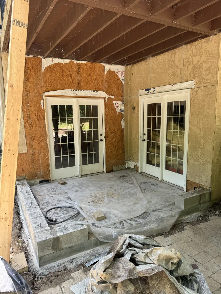 Columbus 2 Story Addition in-progress exterior. New foundation, white French doors, OSB sheathing for home remodeling.