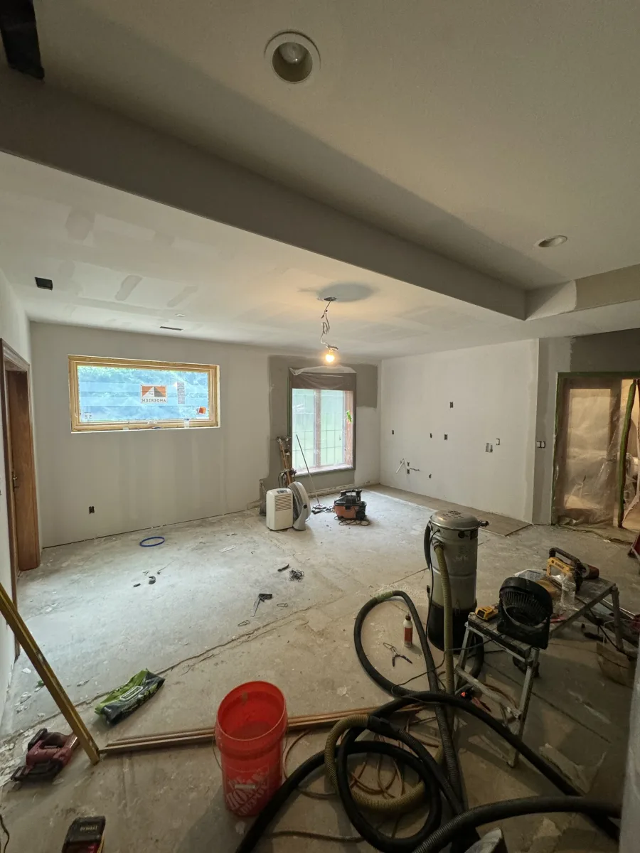 Columbus home addition interior, new drywall, recessed lighting prep, Andersen windows, concrete floor. 614 Remodeling Pros remodeling.
