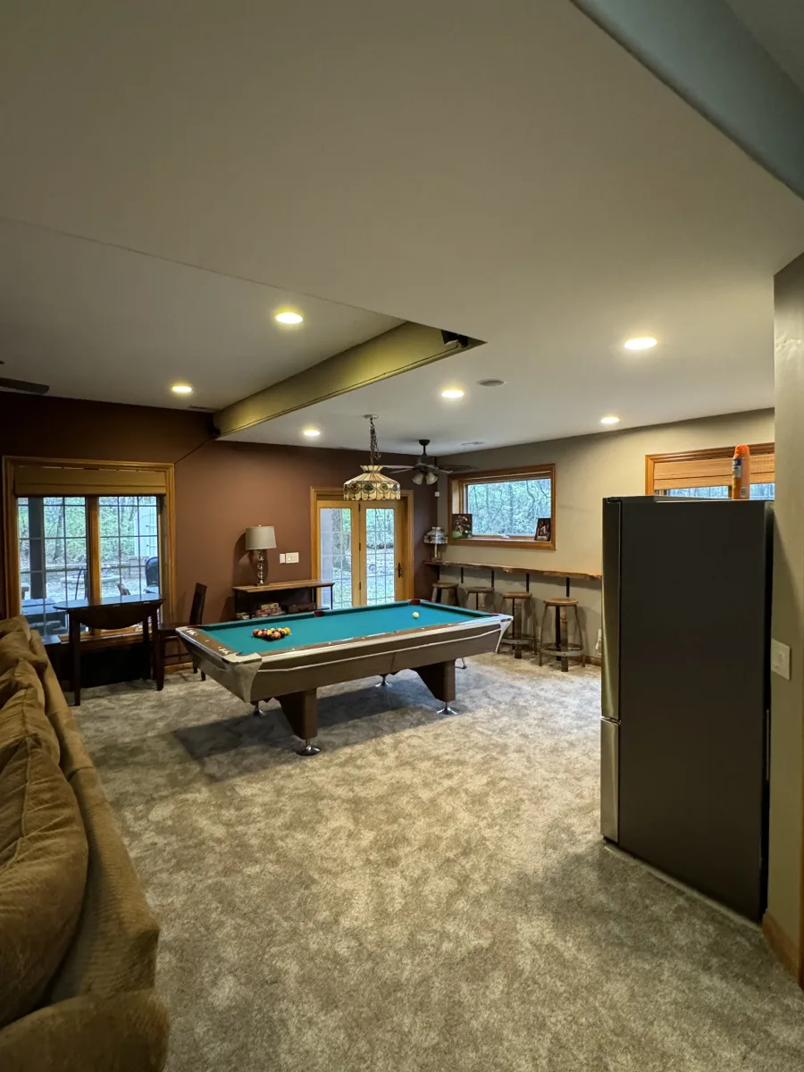 Columbus 2 Story Addition: after, bright new entertainment room with pool table, custom bar, recessed lighting & cozy carpet.