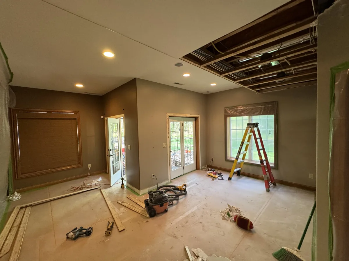 Columbus 2 Story Addition, interior in-progress. Exposed ceiling framing, new recessed lighting, painted walls, French doors, construction tools.