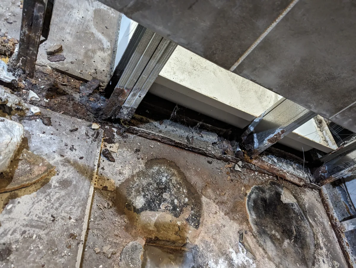 Columbus commercial shower water damage: severe rot, rusted framing, and mold on subfloor before renovation.