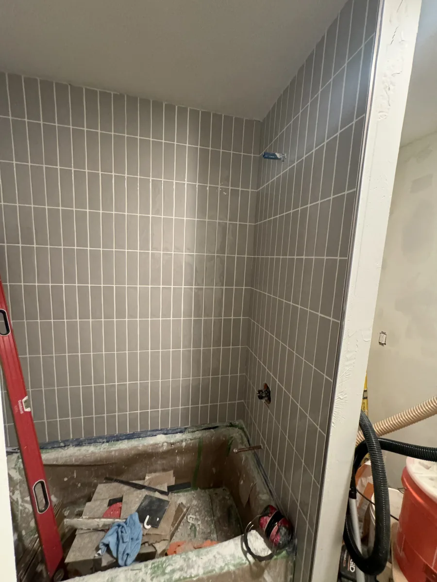 Columbus guest bathroom remodel featuring sleek gray vertical subway tile installed on shower walls.