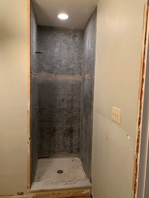 Columbus bathroom remodel in progress: shower area with waterproofed walls, floor, and plumbing rough-ins for new tile.