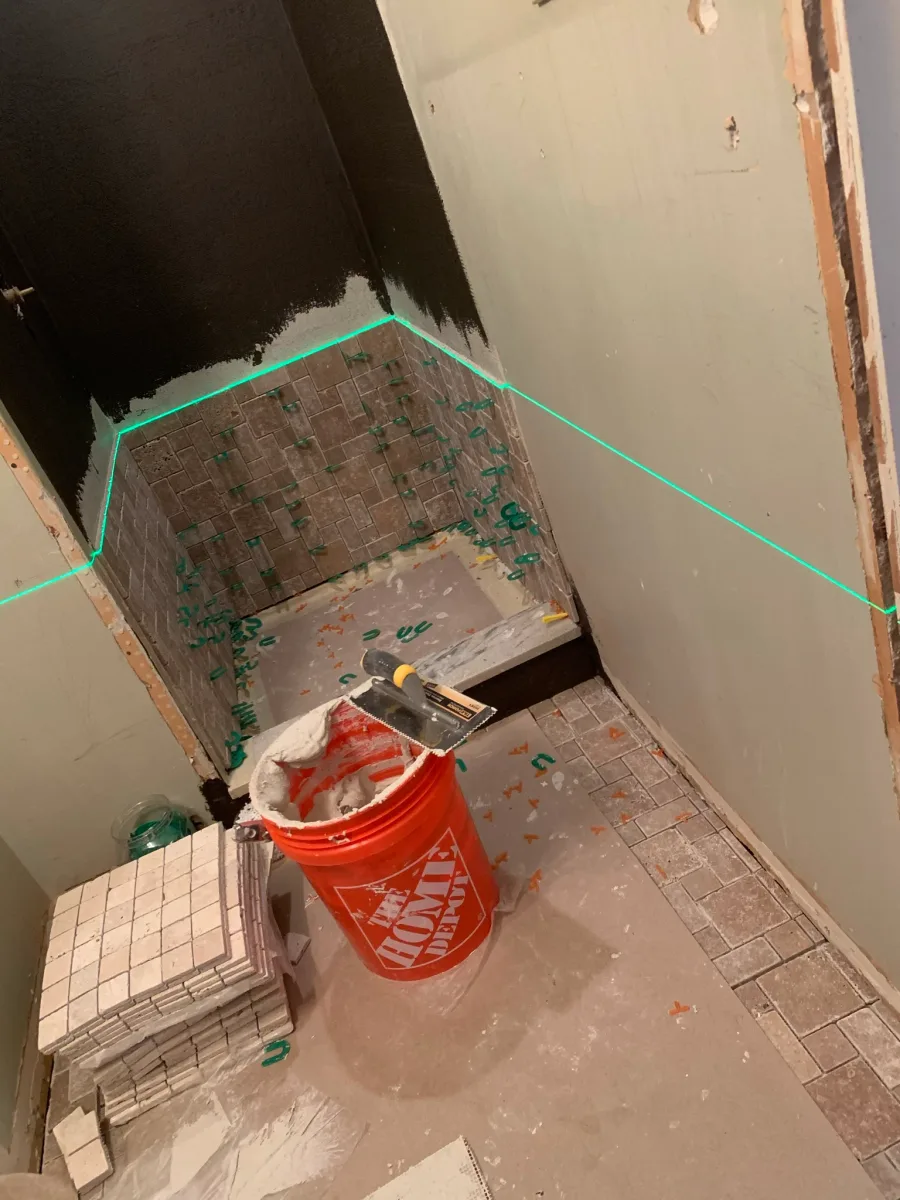 Columbus master bathroom shower & floor tile installation. Brown mosaic shower, beige floor tiles, waterproofing, laser level.